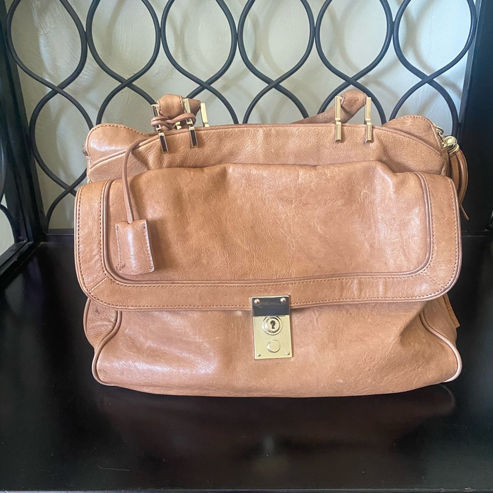 Leather bag with multiple interior & exterior pockets.
